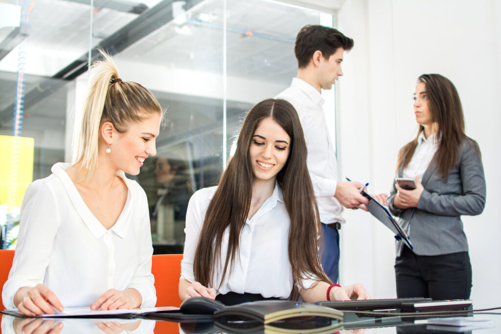 Young professionals collaborating in a modern office, thriving in entry-level jobs.