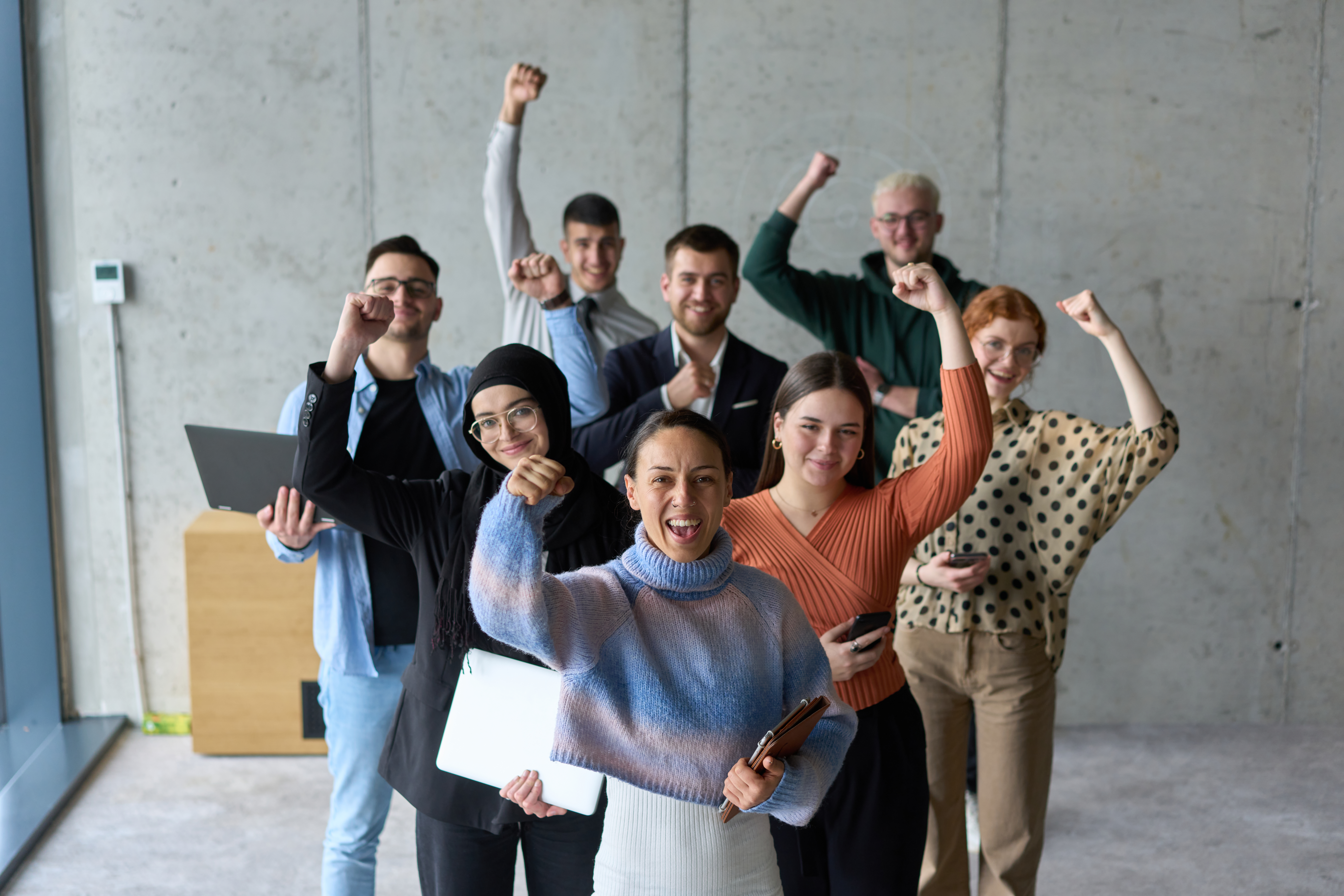 Professionals celebrating team success after achieving a shared business goal.