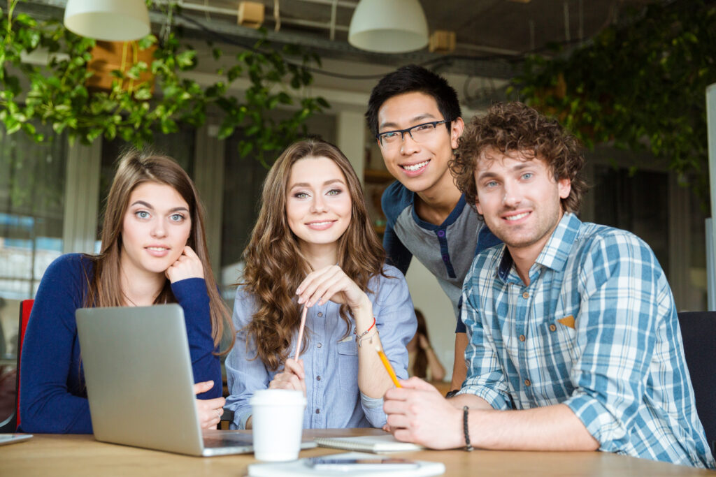 Diverse marketing interns working together to build skills in a collaborative workspace.